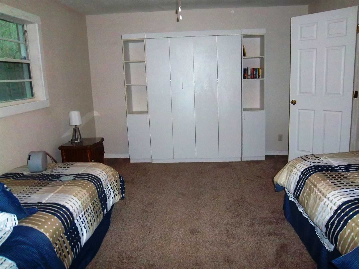 This bedroom has two twin beds,a full murphy bed and an ensu